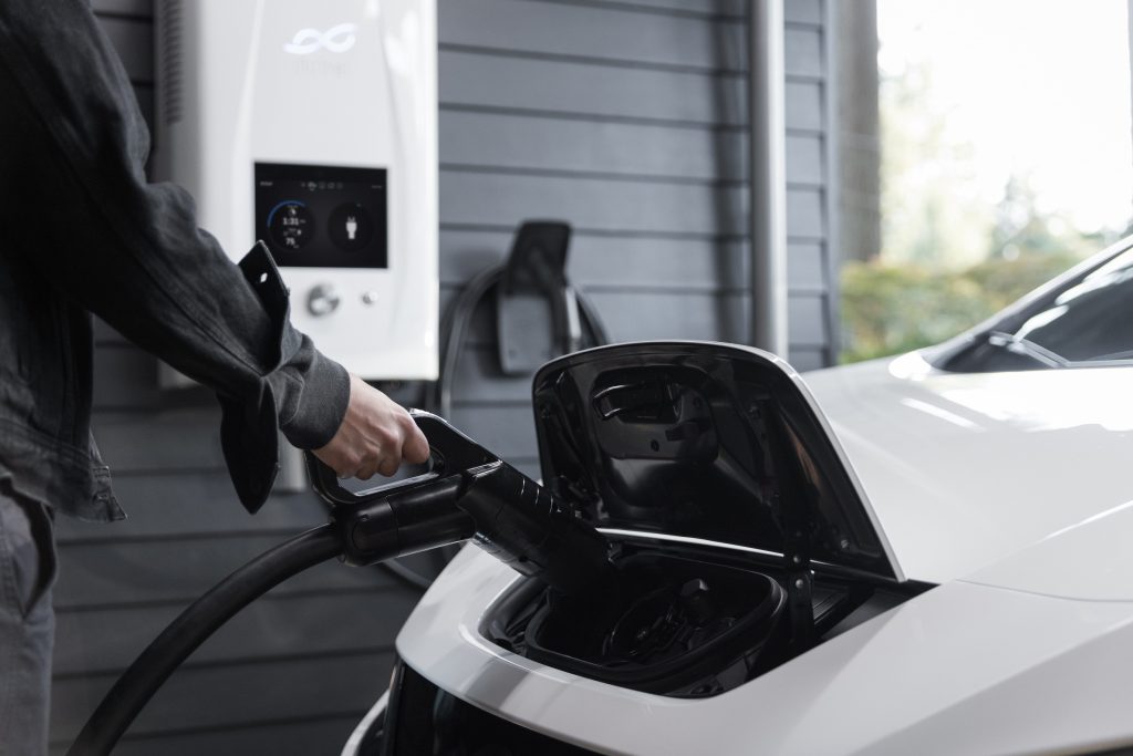 electric-charger-plugged-in-white-car